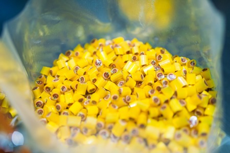 Yellow caramel sweets in transparent plateの写真素材