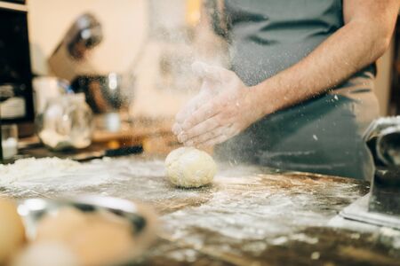 Fresh pasta cooking, chef hands with doughの写真素材