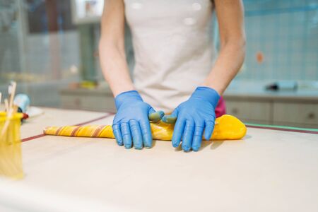 Male chef hands in gloves, caramel making processの写真素材