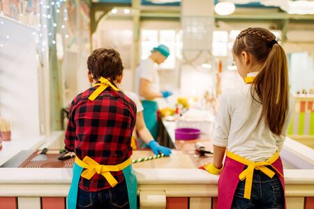 Children at pastry shop learn to make caramelの写真素材