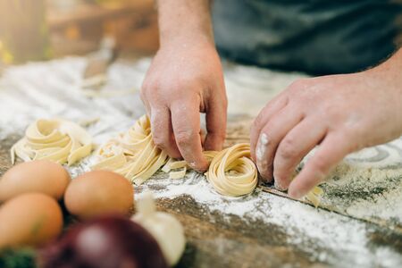 Chef hands preparing pasta, fettuccine preparationの写真素材
