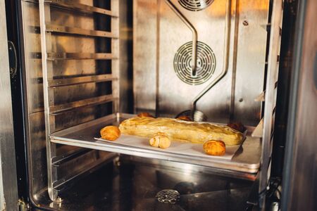 Apple strudel on metal baking sheet in the oven