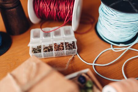 Needlework, box with beads on wooden tableの写真素材
