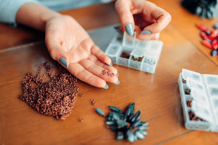 Female hands holds little metal rings, needleworkの写真素材
