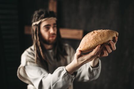 Jesus Christ with bread in hands, sacred food