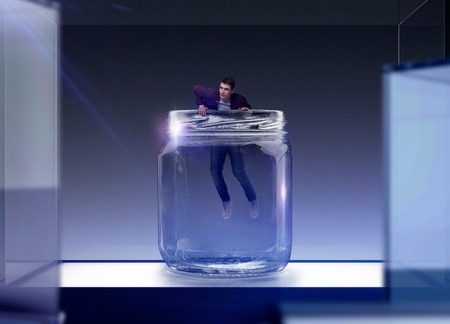 Fear of loneliness, man trying to get out of glassの写真素材