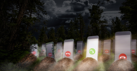 Phone addiction even after death. Cellphone addicted people concept. Graves with smartphones with glowing screens instead of a monument, panoramic viewの写真素材