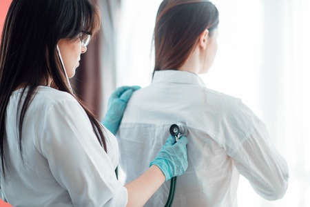 Doctor listens to patient using a stethoscope