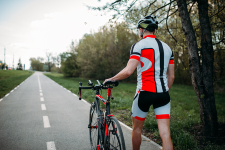 Cyclist in helmet and sportswear rides on bicycleの写真素材