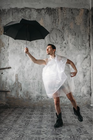 Mad freak man holds umbrella in handの写真素材