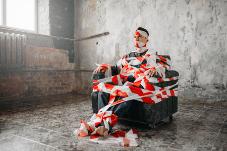Autistic sitting on a chair in the middle of room