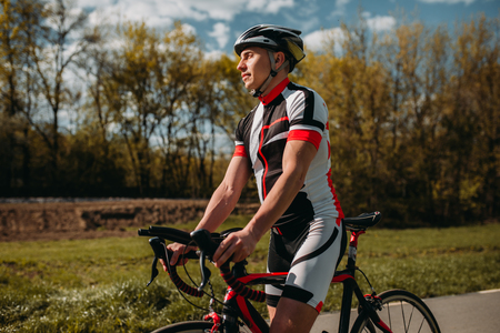 Male bicyclist in helmet and sportswear on bicycleの写真素材