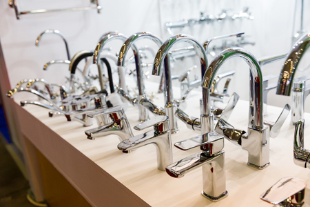 Rows of new faucets in plumbing shop, closeupの写真素材