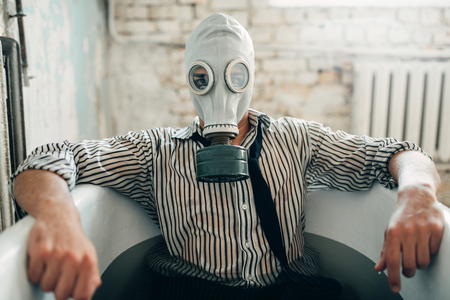Businessman bankrupt in gas mask, suicide manの写真素材