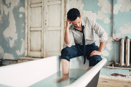 Businessman bankrupt in bathtub, suicide manの写真素材