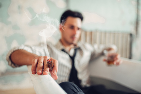 Businessman smoke cigar in bathtub, suicide manの写真素材