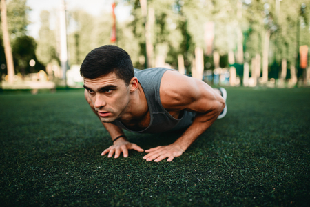 Male athlete doing push-up exercise outdoor