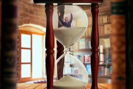 Man drowning inside an hourglass, deadline conceptの写真素材