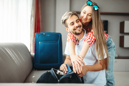 Couple prepares bags and passports for vacationの写真素材
