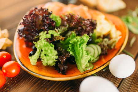 Meat salad in a bowl on wooden table, top viewの写真素材