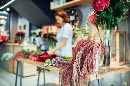 Florist making flowers arrangement in shopの写真素材