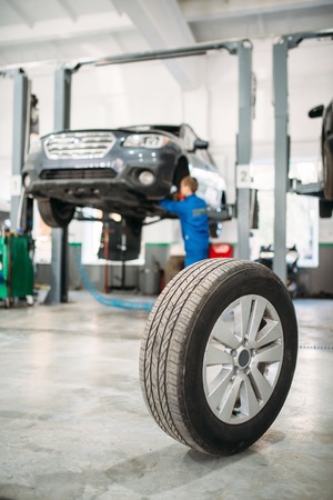 Wheel on the floor in tire service, car on liftの写真素材