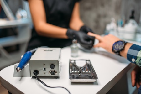 Polishing machine in nail salon, man manicureの写真素材
