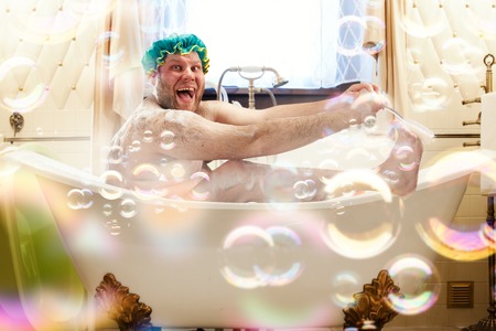 Fat ugly man washing in a bathの写真素材