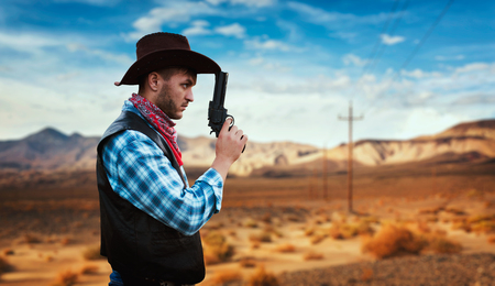Cowboy with revolver, gunfight in gesert valleyの写真素材