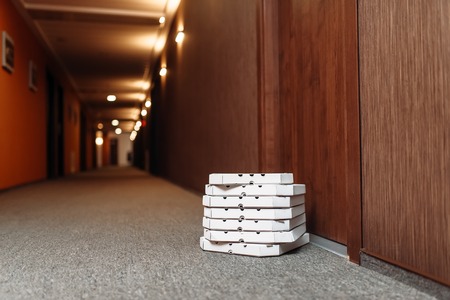 Carton pizza box left at the door, pizza deliveryの写真素材