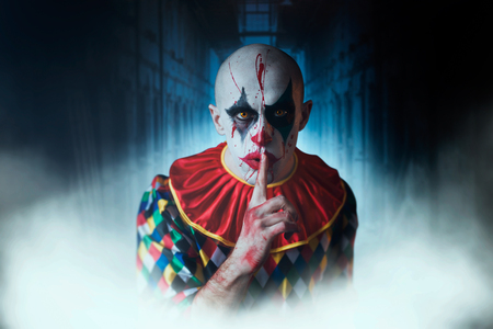 Portrait of mad bloody clown shows the quiet signの写真素材