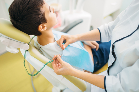 Boy in a dental chair, pediatric dentistryの写真素材