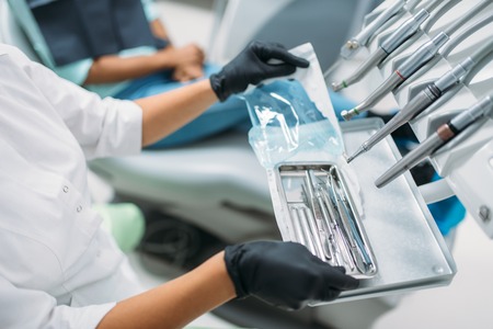Dentist takes instrument, dental clinicの写真素材