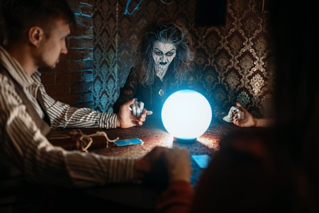 Witch, man and woman on spiritual seanceの写真素材