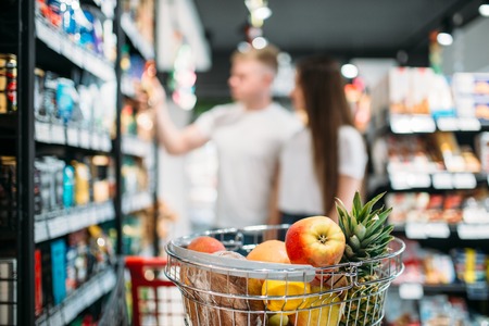 Cart with fresh fruits in food storeの写真素材