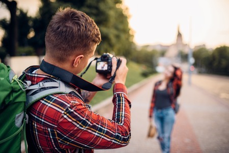 Man makes shoot on camera, woman poses, hiking