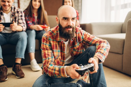 Friends with joysticks plays tv console at home