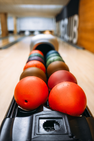 Color bowling balls in feeder, bowl game conceptの写真素材