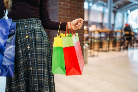 Female person with shopping bags in mall