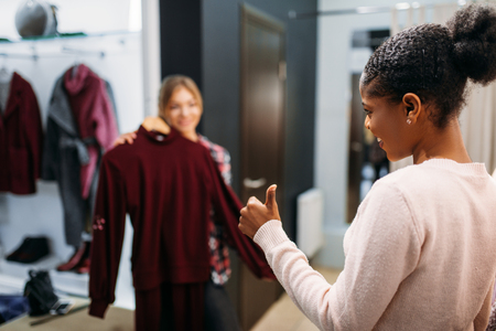 Two women choosing clothes, shoppingの写真素材