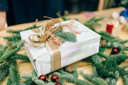 Gift box in wrapping paper, fir branch decorationの写真素材