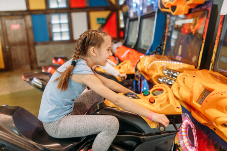 Two girls plays game machine, entertainment centerの写真素材