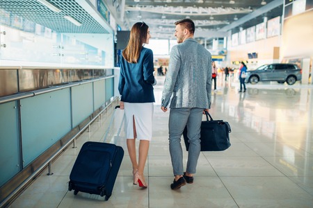 Business class passengers with luggage in airportの写真素材