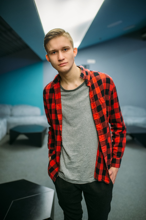 Male teenager in cinema hall before the showtimeの写真素材