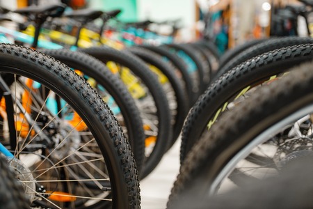 Rows of cycles in sports shop, focus on wheelsの写真素材