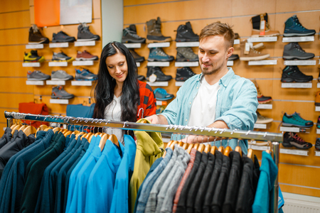 Couple choosing cycling suits, sports shopの写真素材