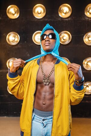 Black rapper, perfomance on stage with spotlightsの写真素材