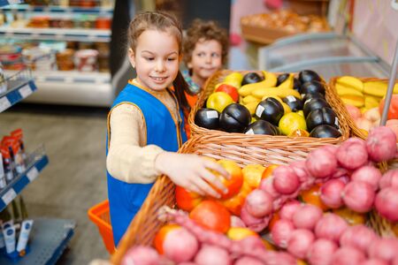 Girl in uniform playing saleswoman, playroomの写真素材