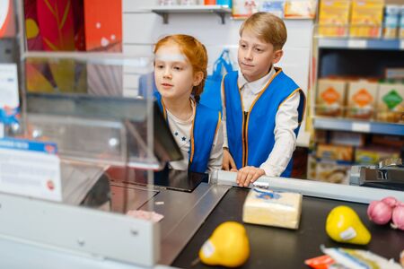 Girl and boy in uniform at the register, sellersの写真素材