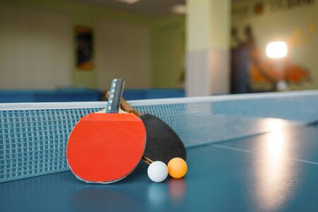Two  paddles on the table with net